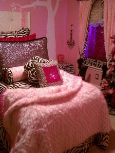 a bedroom decorated in pink and zebra print