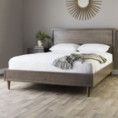 a large bed sitting in a bedroom on top of a hard wood floored floor