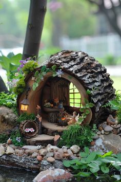 a fairy garden with a tree stump house