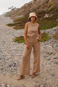 Style // A beautiful brown linen top, the perfect addition to any wardrobe The Mila Top is the perfect effortless and minimal design for the ultimate laid back look. A high neck sleeveless linen top, featuring a mother of pearl button on the back. The rounded neckline can be dressed up or down, making it your new go to top Fabric Note // Made in Italy from 100% Linen Sizing Advice // Available in three sizes, S: Bust: 36" Length: 20" M: Bust: 38" Length: 21" L: Bust: 40" Length: 22" Care Instruc Brown Linen Tops For Vacation, Brown Sleeveless Linen Top, Sleeveless Brown Linen Top, Postpartum Pants, Linen Matching Set, Linen Set Outfit, Brown Linen Pants, Clothes Basket, High Neck Sleeveless