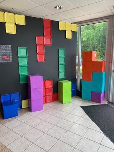 colorful cubes are arranged on the wall in an office