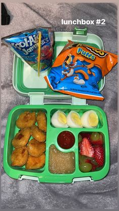 a lunch box filled with fruit and snacks