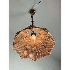 a light hanging from the ceiling with an umbrella design on it's back end