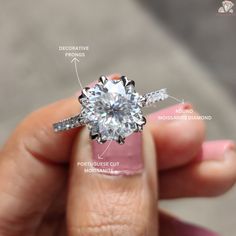 a woman's hand holding an engagement ring with information about the diamond and its features