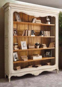 an old fashioned bookcase with many books on it