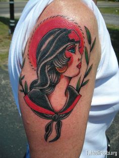 a woman's arm with a tattoo on it and a red circle around her neck