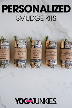 the personalized smudge kits are lined up on a white marble surface with bamboo sticks wrapped around them