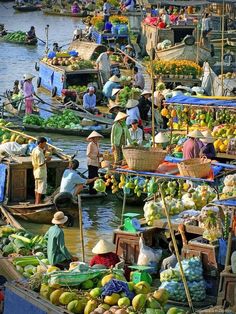 people on boats filled with fruits and vegetables