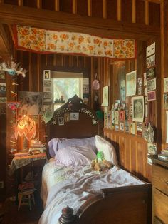 a bed sitting in a bedroom next to a wooden dresser and window with pictures on the walls