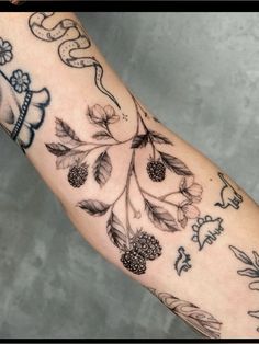 a person's arm with tattoos on it