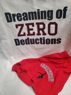 This listing is for a custom Dreaming of Zero Deducations pajama set.  Included in this set is a short sleeve t-shirt and a pair of shorts. If you are looking for something specific send us a message.  Please be careful to choose the correct sizes, after the products are customized returns will not be accepted.  The shirts are Gildan brand and the shorts are Soffee brand.    **Sizing is in YOUTH sizes** if you need adult sizes please message us and we will let you know if we can accommodate your order** ** Please send us a message for custom order or order of a large quantity.  ** Casual Cotton Sleepwear For Gift, Red Cotton Pajama Shorts For Sleepover, Sporty Cotton School Sets, Fitted Cotton Cheerleading Sets, Relaxed Fit Cotton Sets With Letter Print, White Cotton Cheerleading Sets, White Cotton School Spirit Sets, Cotton Sleepwear With Letter Print And Relaxed Fit, Cotton Sleepwear With Letter Print In Relaxed Fit