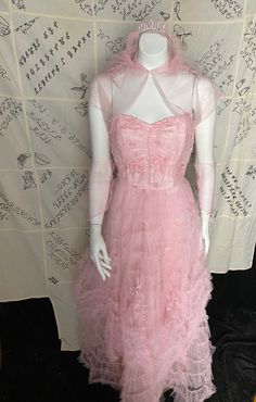 1950's bubblegum pink strapless tulle party dress with matching sheer bolero, sleeveless gloves and tiara with veil. Great vintage condition, metal zipper up the back and bodice boning.  Womens xs 34" bust 24" waist 44" max hips 8.5" armpit to waist 41" waist to hem 1950s Style Pink Party Dress, 1950s Style Pink Dress For Vintage Events, Vintage Strapless Pink Dresses, 1950s Style Spring Prom Dress, 1950s Style Pink Dresses With Fitted Bodice, 1950s Pink Evening Dress, Pink Dress With Fitted Bodice For Vintage Events, Pink 1950s Evening Dress, 1950s Style Pink Evening Dresses