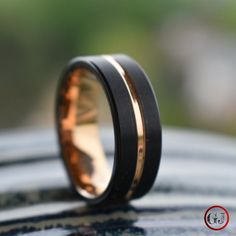 a black and gold wedding band on top of a car