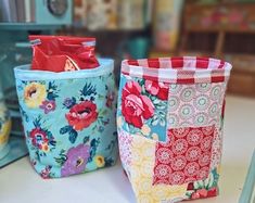 two fabric storage baskets sitting on top of a table