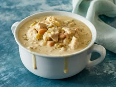 a white bowl filled with soup on top of a blue table