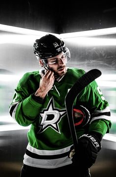 the hockey player is talking on his cell phone