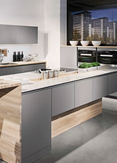 a modern kitchen with an island in the middle