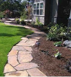 a stone walkway in front of a house