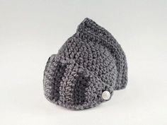 a gray knitted hat with buttons on it