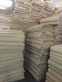 stacks of white linens stacked on top of each other