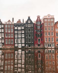 many buildings are reflected in the water