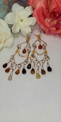 Beautiful Carnelian and 14K Gold Filled Teardrop Gemstone Chandelier Earrings. They are elegant and dangly with a Bohemian twist. Handmade of high quality 14 karat gold filled wire, 14 karat gold filled chain with carnelian teardrop gemstones. These earrings have classic lines and are perfect for day wear or a special evening out. These Carnelian Gemstones (approx stone size is 9.95mm x 6.64 mm )are in complementary shades of cream and peaches on 14K Gold Filled wire. Uniquely created, Handmade Bohemian Drop Pierced Earrings, Bohemian Teardrop Chandelier Earrings With Natural Stones, Bohemian Amber Drop Earrings, Bohemian Chandelier Dangle Earrings With Natural Stones, Bohemian Amber Earrings With Ear Wire, Brown Dangle Chandelier Earrings With Beads, Bohemian Wire Wrapped Long Drop Chandelier Earrings, Bohemian Amber Dangle Earrings, Brown Wire Wrapped Dangle Earrings