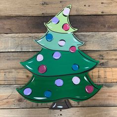 a green ceramic christmas tree sitting on top of a wooden wall