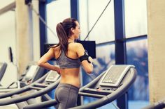 a woman running on a treadmill in a gym