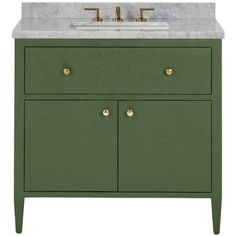 a green cabinet with two sinks and gold faucets on the top, against a white background