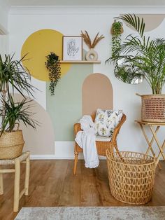 a living room with potted plants on the wall and wicker chairs in front of it