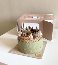 there is a cake with shells on it in the shape of a bird's nest