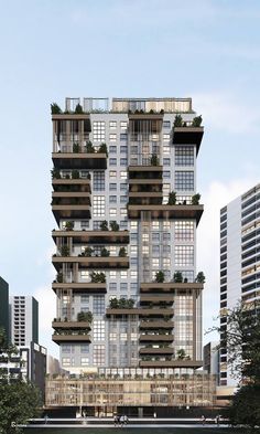 a tall building with lots of windows and plants on the balconies above it