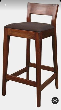 a wooden bar stool with a black seat pad on the bottom and backrest, against a white background