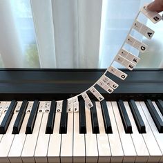 a person is playing on a piano with musical notes attached to the keys and strings