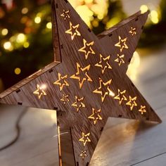 a wooden star with gold stars on it