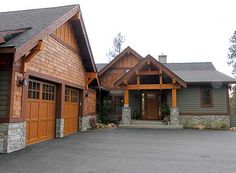 a large house with two garages on each side