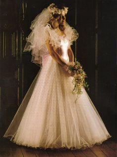 a woman in a wedding dress holding a bouquet