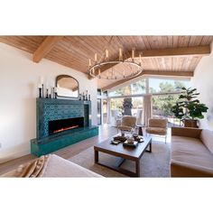 a living room filled with furniture and a fire place in the middle of a room