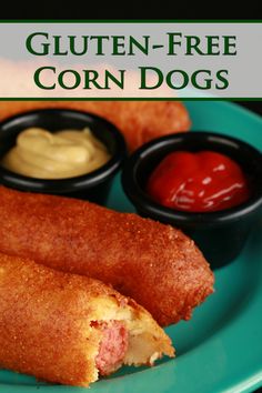 a close up of a plate of food with corn dogs and ketchup on the side