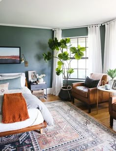 a living room with two chairs and a rug in front of the window, along with an area rug on the floor