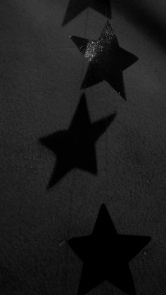 five stars are placed on the ground in black and white