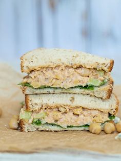 two sandwiches stacked on top of each other with chickpeas and lettuce