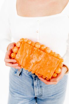 Our Daphne clutch is an exquisite fashion statement. Hand crafted and beautifully made, this piece is truly a work of art! This clutch is fashioned with beaded accents around the edges of the purse. Engraved with the LINNY CO brand on reverse side of the purse. Details and materials are outlined below. Material: Acrylic Color: Marbled Orange Unlined Fits an iPhone 14, lip gloss, keys and card case Snap Closure Size of actual bag exclusive of the beaded accents: 18x10x4.5mm Handle with care, coul Chic Beaded Handheld Clutch, Elegant Orange Rectangular Evening Bag, Chic Beaded Pouch Clutch, Elegant Orange Clutch As A Gift, Orange Rectangular Clutch For Formal Occasions, Chic Beaded Clutch As A Gift, Orange Rectangular Formal Clutch, Elegant Orange Rectangular Clutch, Elegant Orange Clutch For Party