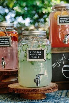 three mason jars filled with liquid sitting on top of a table next to each other