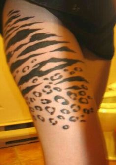 a woman's leg with an animal print pattern on the bottom half of her thigh