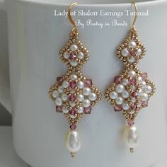 a close up of a pair of earrings on a cup