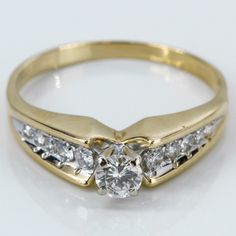 a yellow gold ring with three diamonds on it