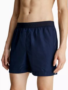 Featuring minimal styling, this swim brief is designed with a tonal elastic waistband for a clean look. Made with a medium rise waist and styled with slip pockets at the sides. Finished with a Calvin Klein logo detail along the waistband. Clean Look, Swim Brief, Swim Shorts, Calvin Klein, Swimming, Elastic, Design