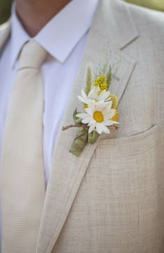 a man in a suit with a flower on his lapel