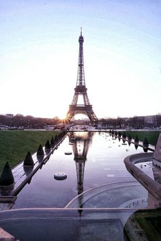 the eiffel tower is reflected in the water